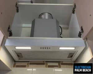 A modern kitchen range hood with integrated lighting, showing a sleek design above the cooktop