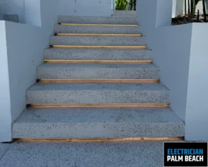 Concrete stairs with LED lighting installed along the edges of each step, casting a soft warm glow, and surrounded by white walls